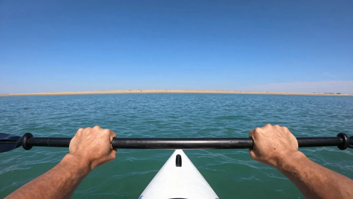Close-up of a paddler's hands gripping the paddle shaft at should